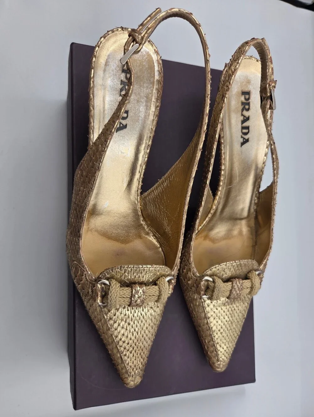 Pre- owned Prada snakeskin braided accents slingback pumps in a metallic gold